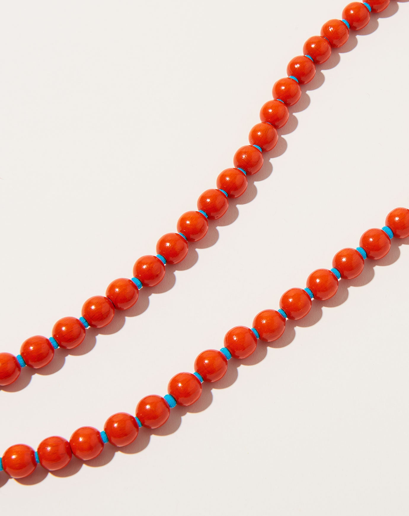 Ina Seifart Perlen Long Keyholder in Orange on Turquoise
