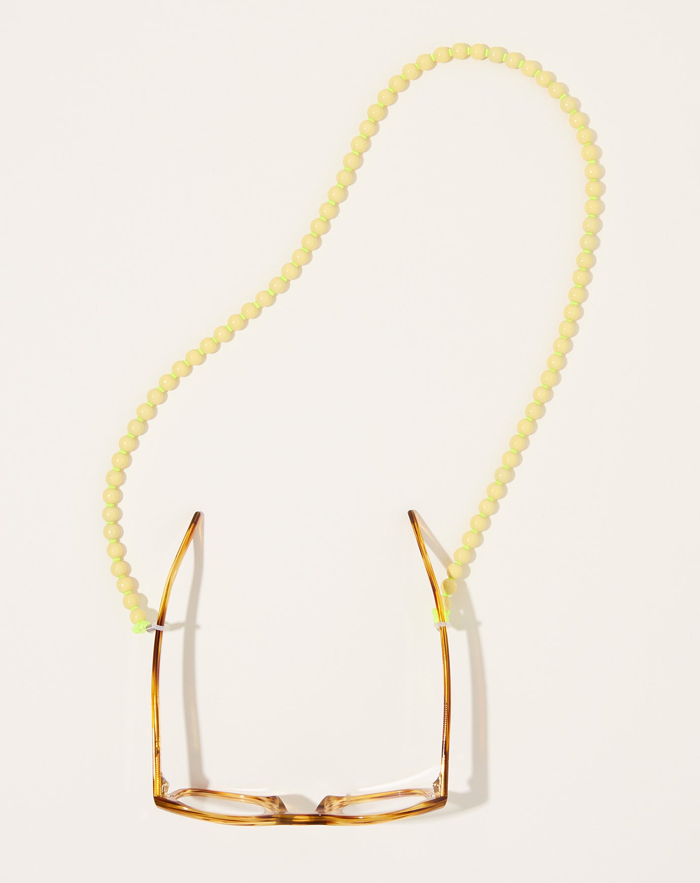 Ina Seifart Brillenkette Eyeglass Chain in Pastel Yellow on Neon Yellow