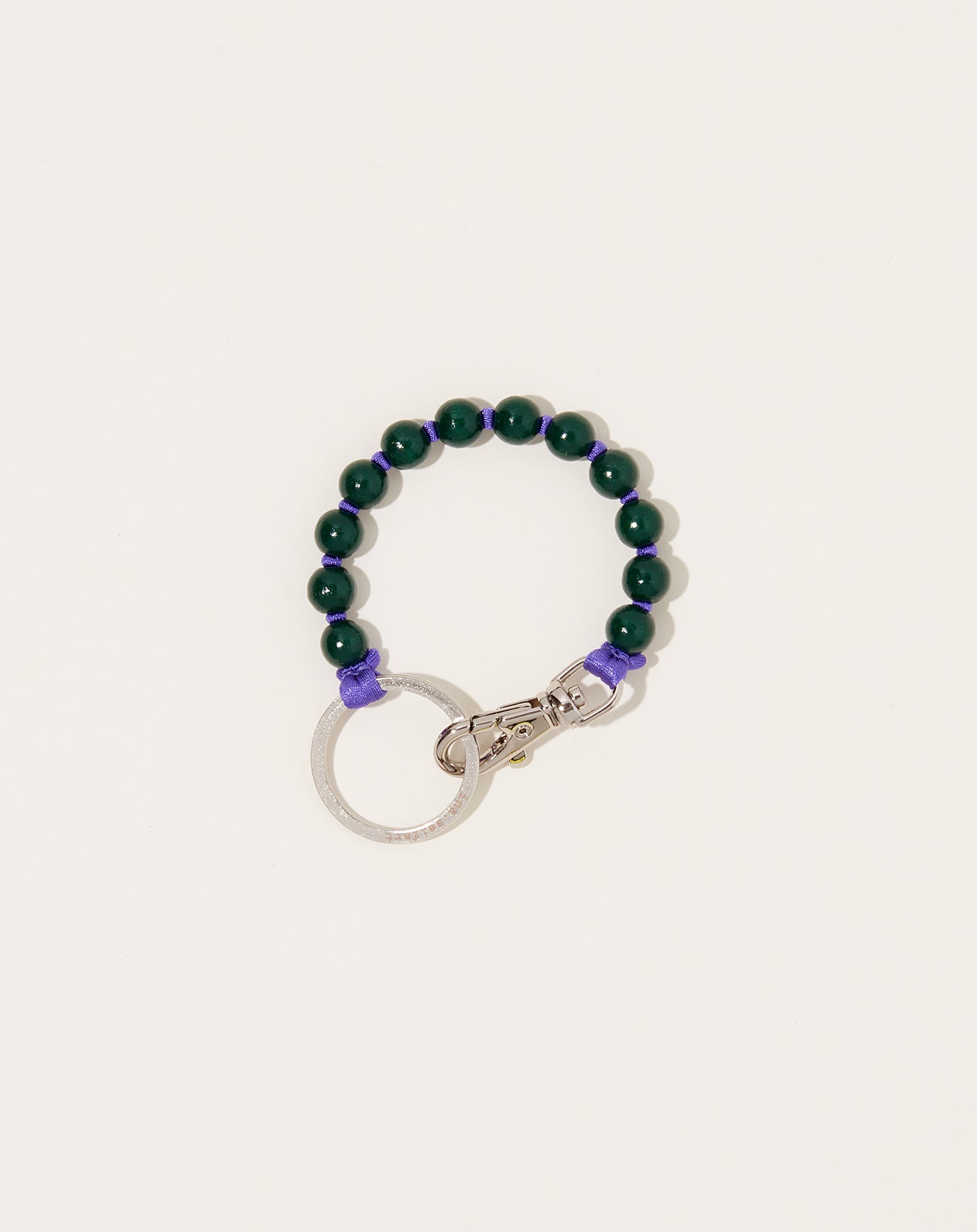 Ina Seifart Perlen Short Keyholder in Dark Green on Purple