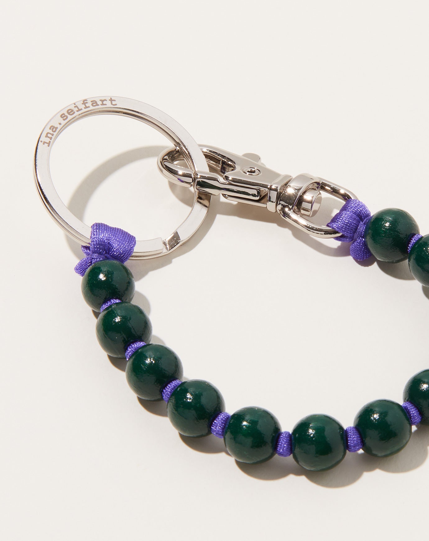 Ina Seifart Perlen Short Keyholder in Dark Green on Purple