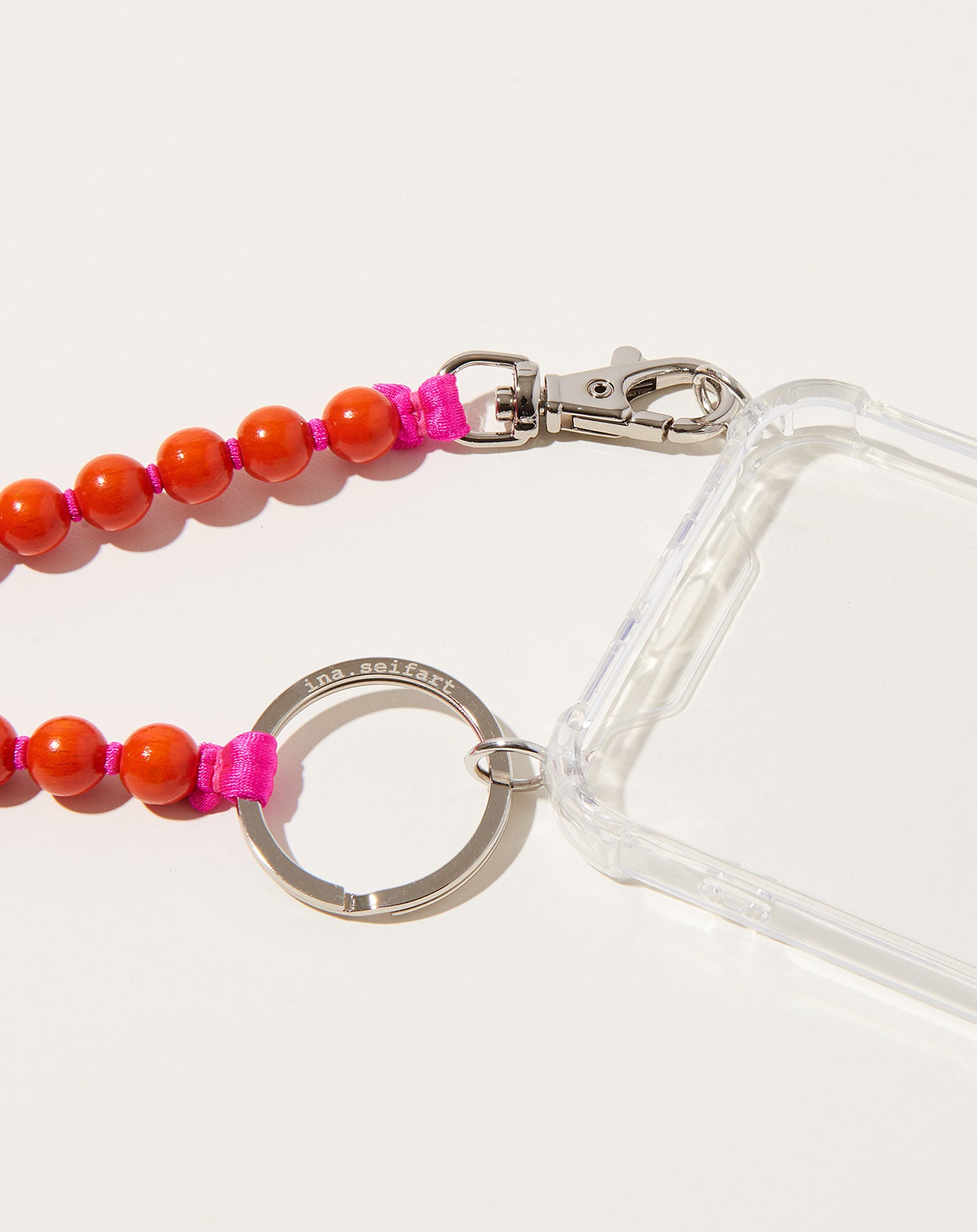 Ina Seifart Handykette iPhone Necklace in Orange on Pink
