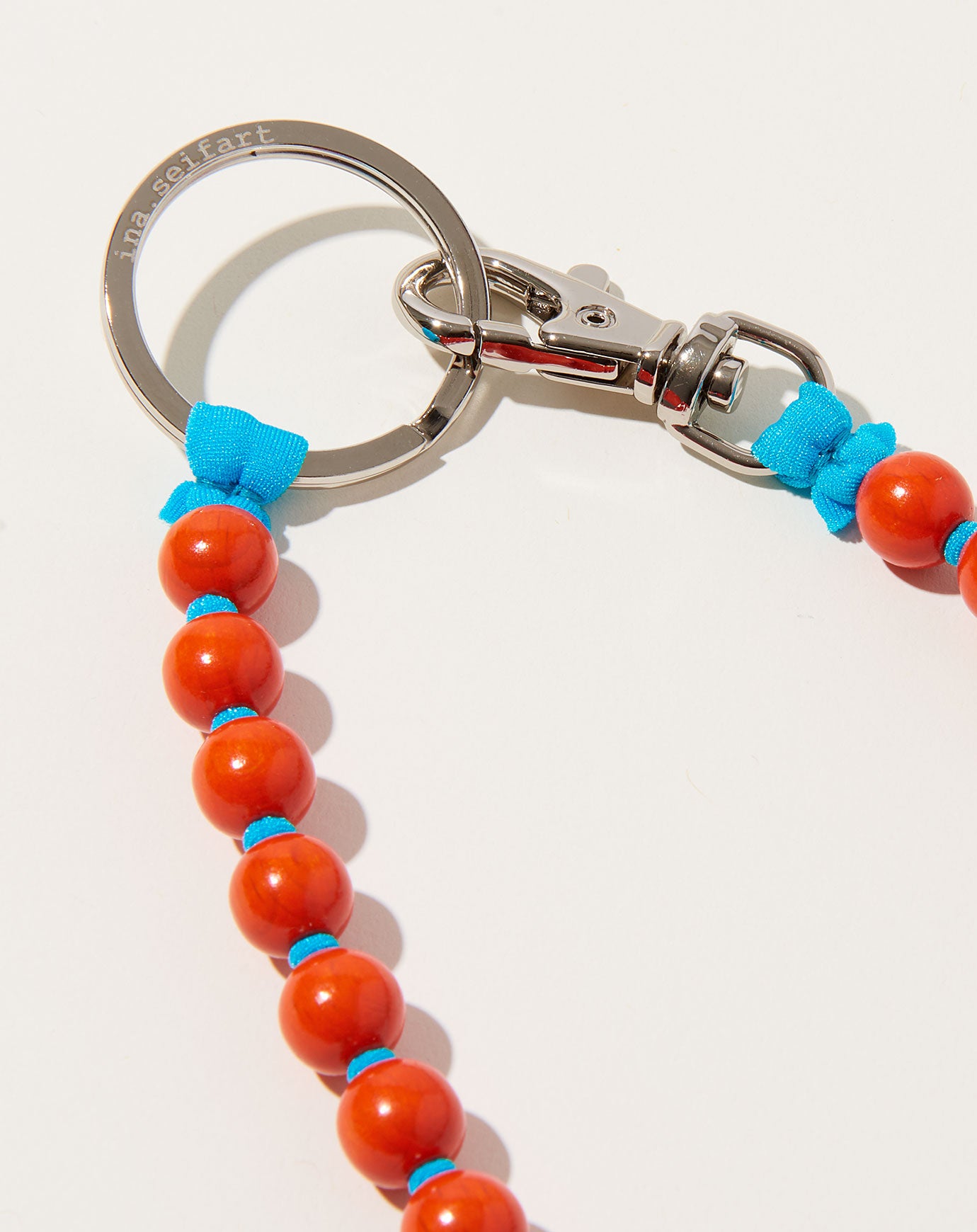 Ina Seifart Perlen Long Keyholder in Orange on Turquoise