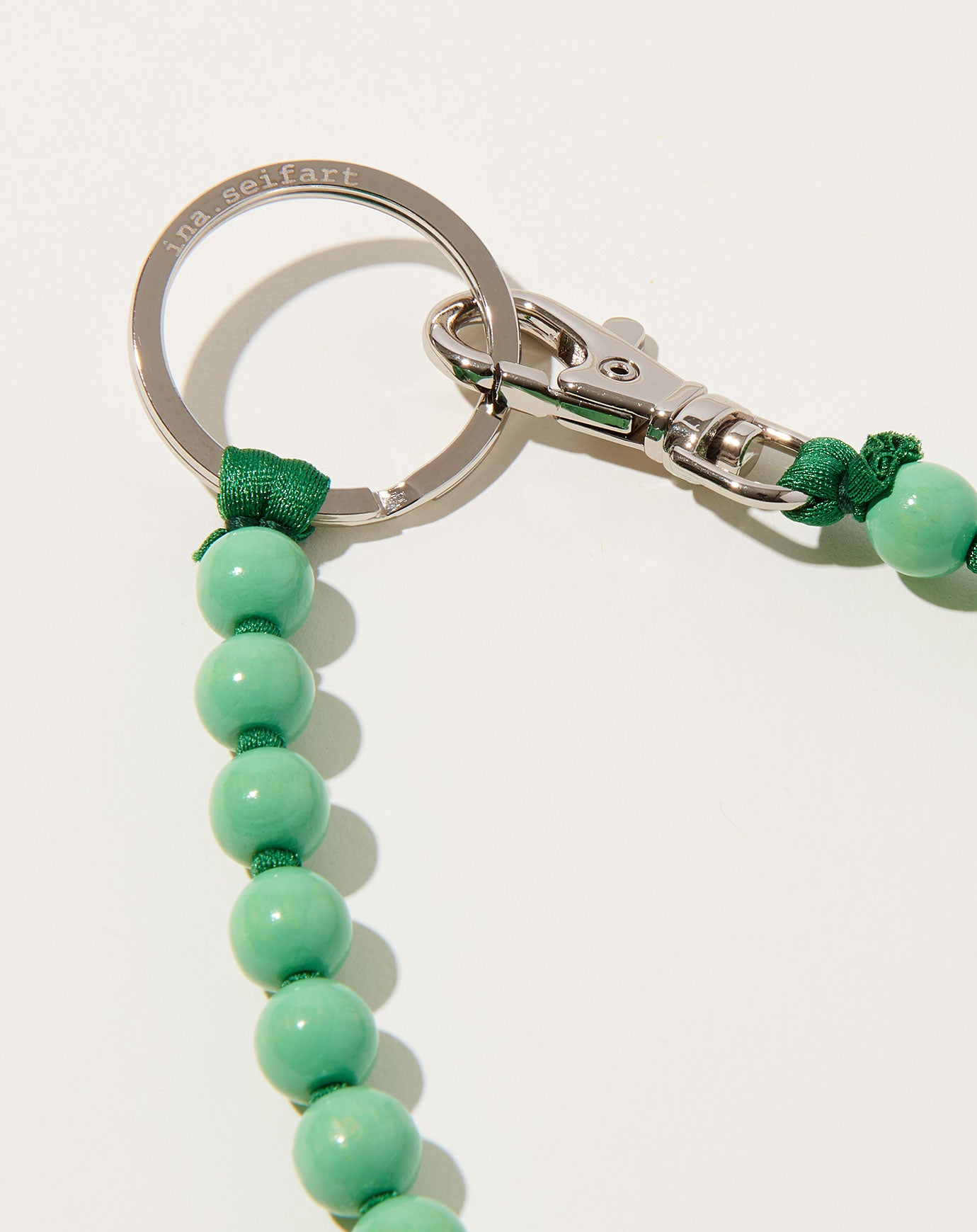 Ina Seifart Perlen Long Keyholder in Pastel Green on Dark Green