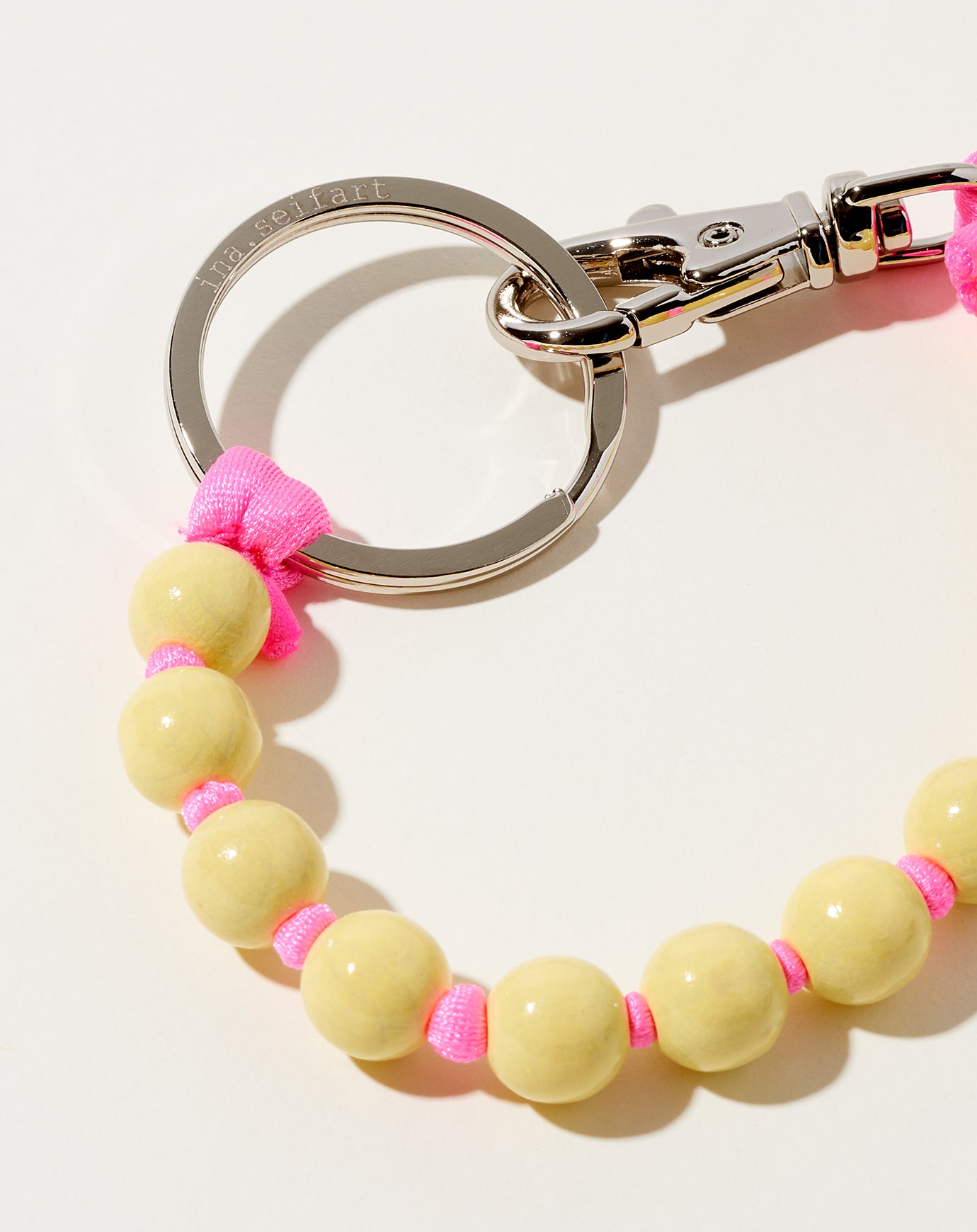 Ina Seifart Perlen Short Keyholder in Pastel Yellow on Pink